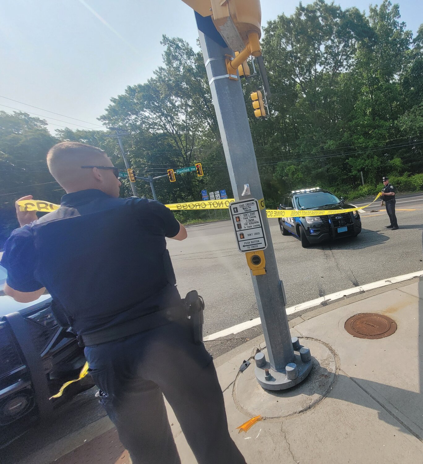 BLOCKING THE STREET: Cranston Police ran crime scene tape across Plainfield Pike early Wednesday morning, May 24, after police shot a man wanted in a Johnston triple-shooting.